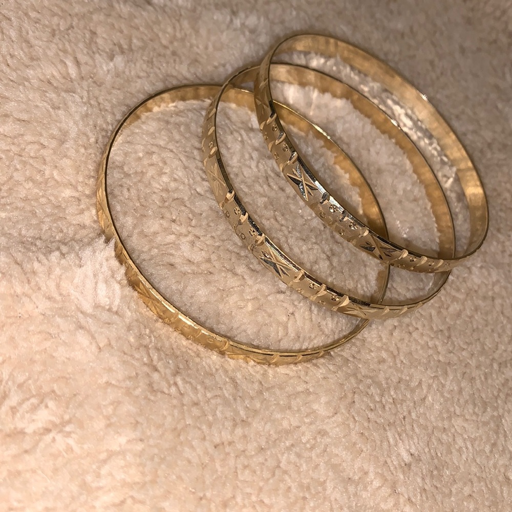Three bangle bracelets gold